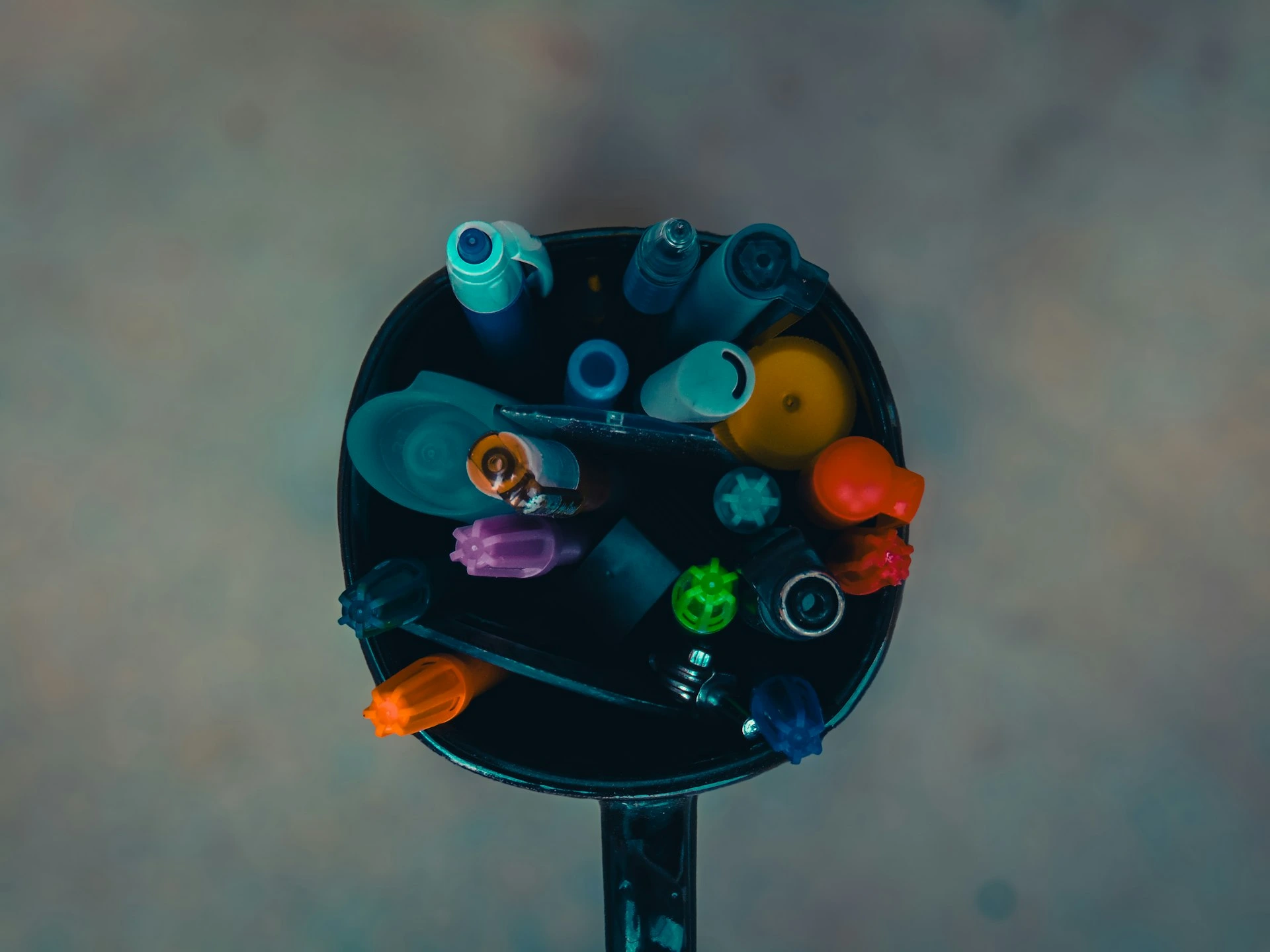Assorted pens and markers in a holder.